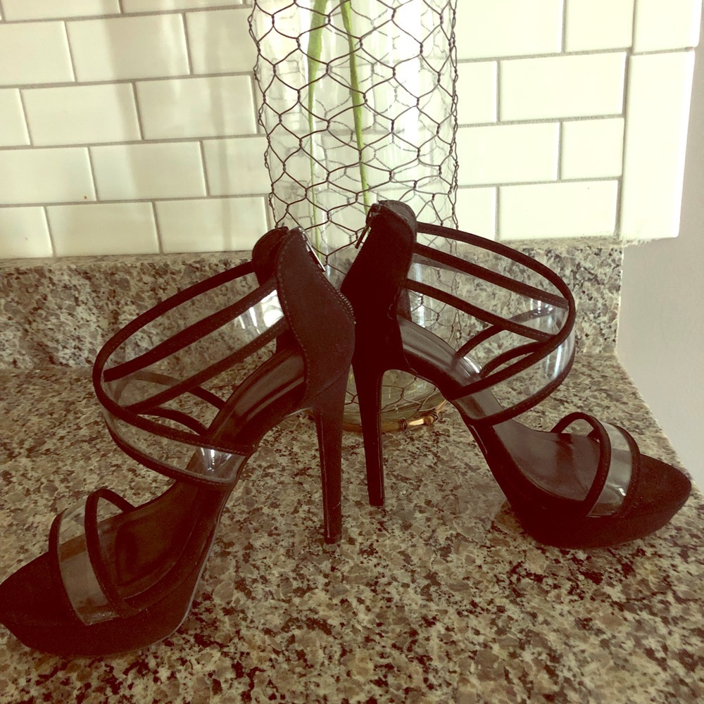 Black strapped heels with clear accents.